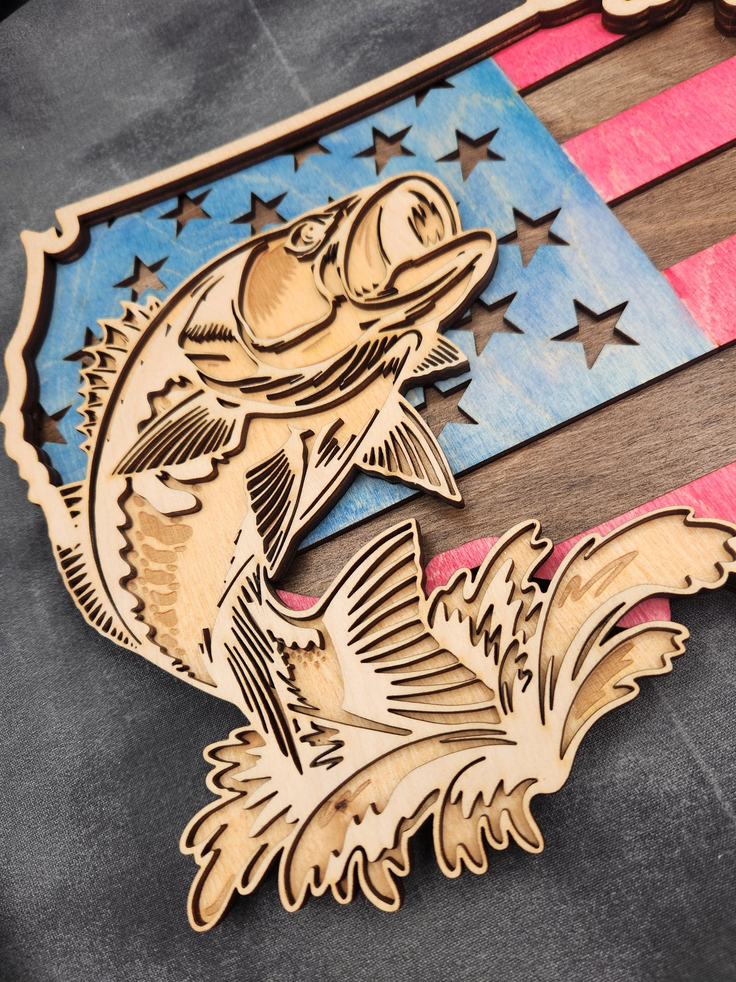 Wooden fish-shaped ornament with star design on a gray background