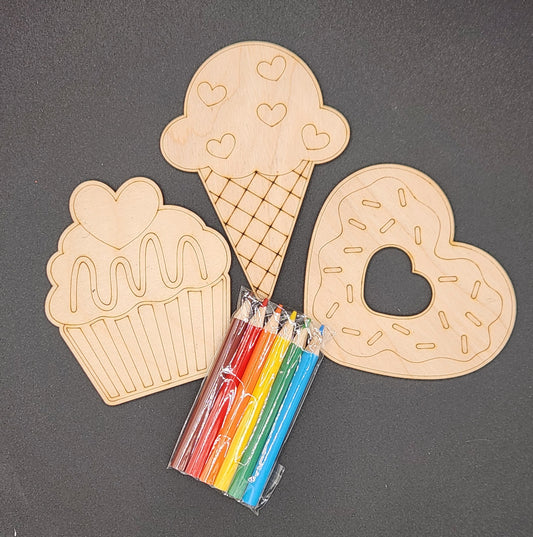 Three wooden craft shapes designed to look like a cupcake, an ice cream cone, and a heart, accompanied by a set of six colored pencils.